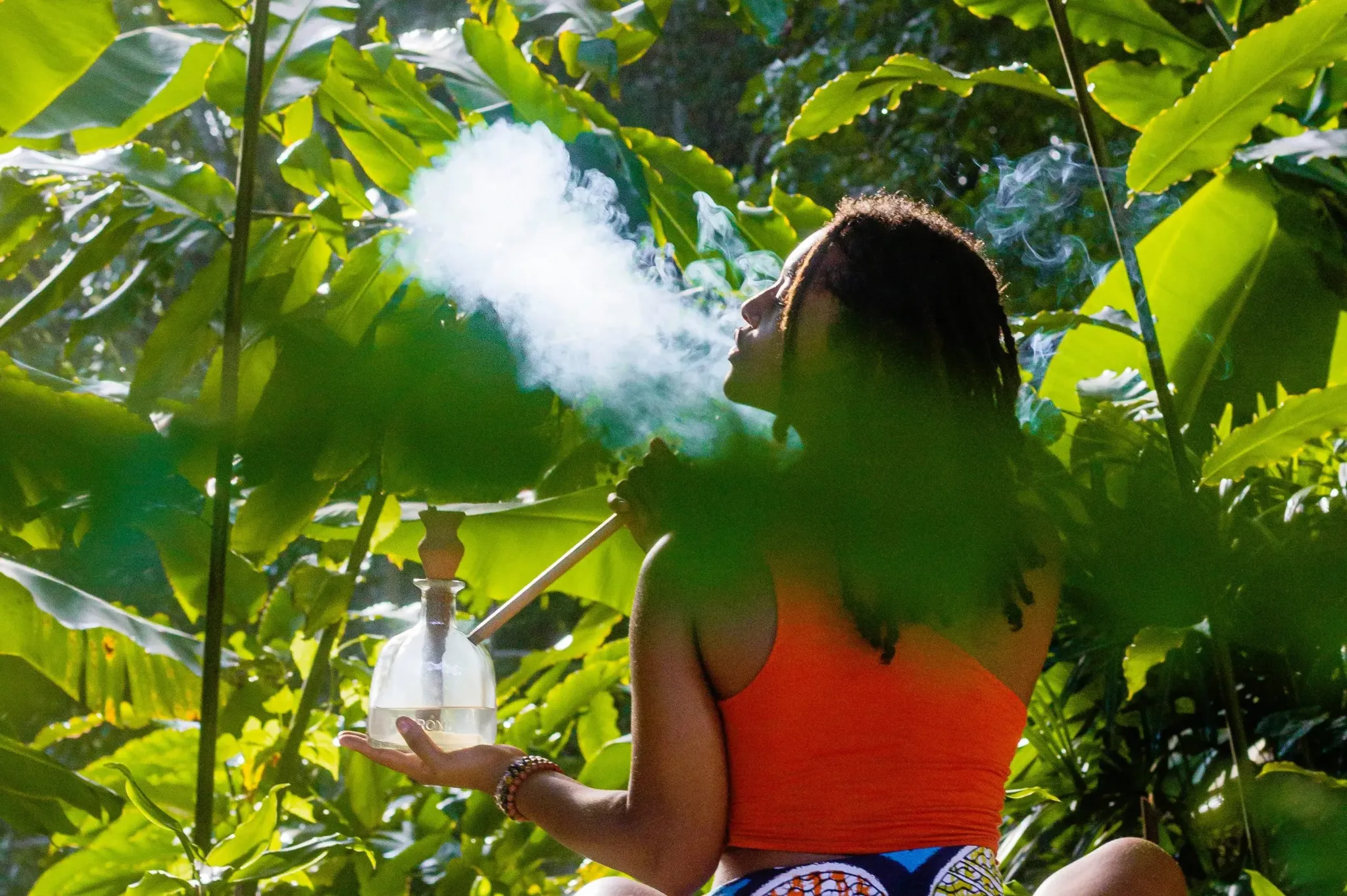 Adult using an authentic steam chalice in a tropical garden